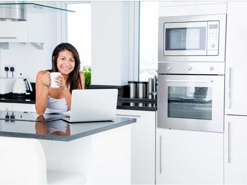 Woman leans on new composite stone benchtop Rocklea